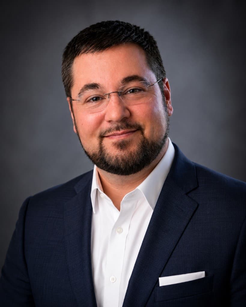 Studio portrait of Nick Schrubbe, Founder and CEO of Material Integrity Advisors